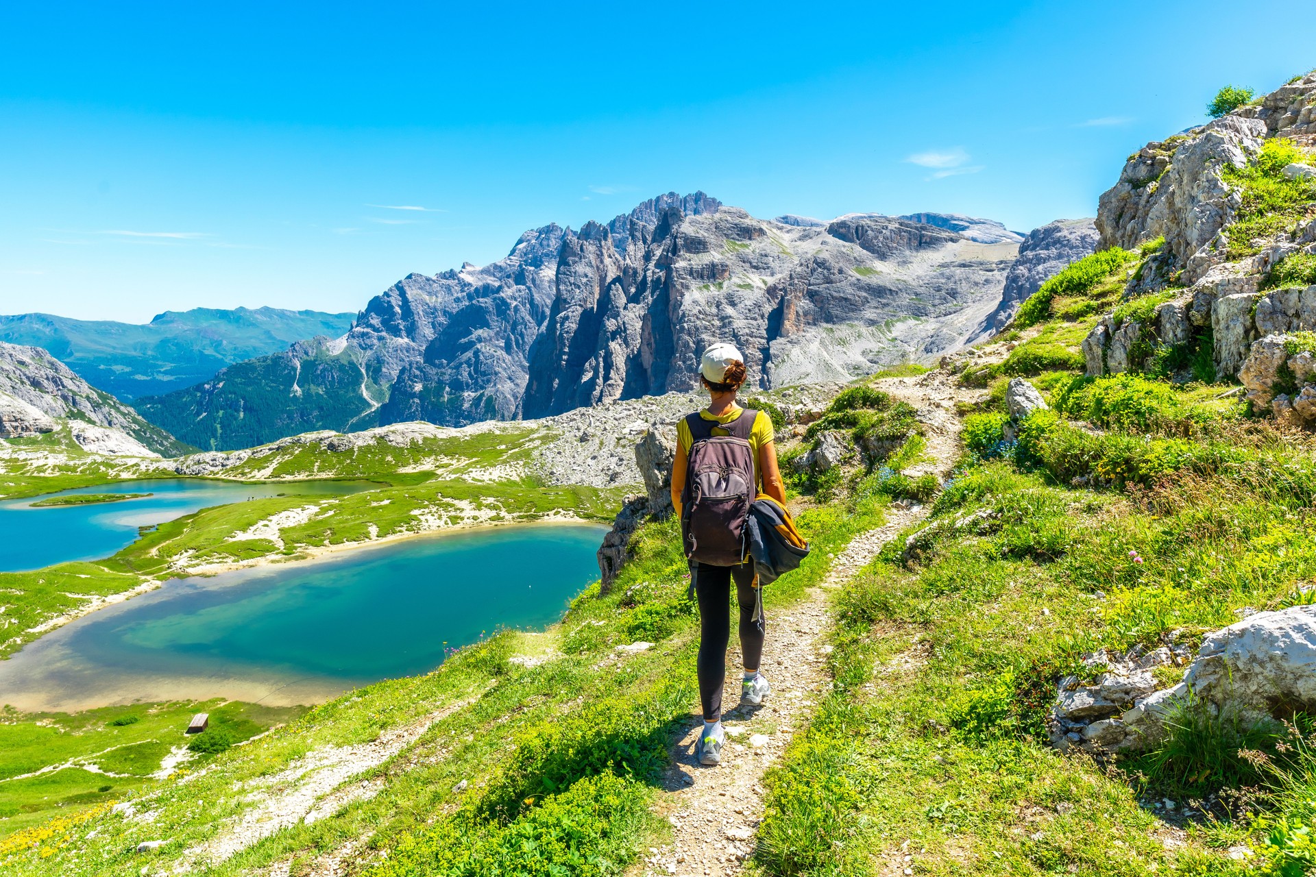Tourist walking on the tre cime di lavaredo trail in the dolomites, italy